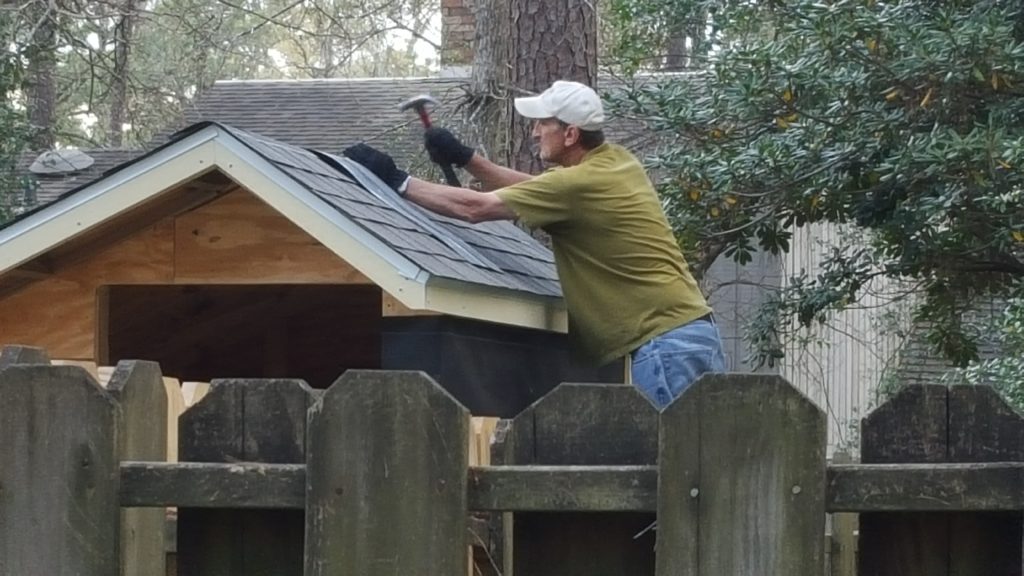 Martin shingling the roof.